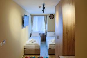 a small room with two beds and a window at FourMountains-Trebević in Sarajevo +13 photos