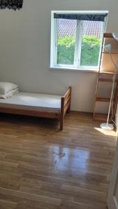 a room with a bed and a window and a ladder at Green House Copenhagen in Copenhagen