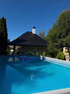 a swimming pool in front of a house at Soko House in Sokolac