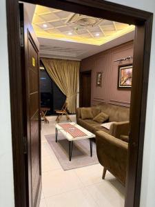 a living room with a couch and a table at Royale Rest Suites in Rāmkot