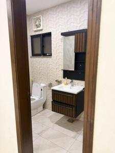 a bathroom with a toilet and a sink at Royale Rest Suites in Rāmkot