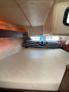 a pair of scissors sitting on a bed in a camper van at The Happy Sailor in Viana do Castelo +62 photos