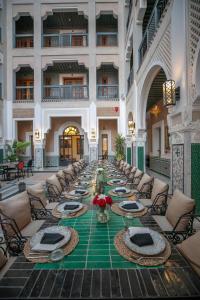 a long table in a building with chairs and tables at Dar Lys Luxury Riad & Spa in Fez