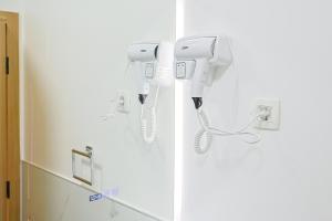 two phones are hanging on a wall in a bathroom at FourMountains-Trebević in Sarajevo