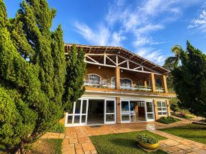 a large house with trees in front of it at Pousada Sítio das Cerejeiras in São Roque