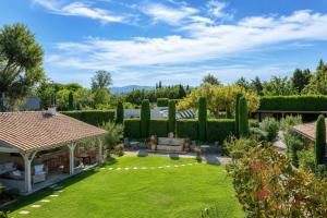 a garden with a gazebo and a lawn at Residence Melody - Adult only in Saint-Rémy-de-Provence