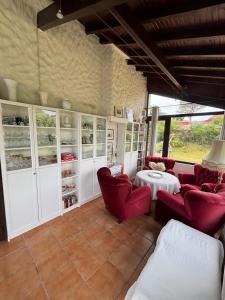 a living room with red chairs and a table at Villa Azkanean in Bidart