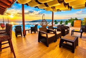 a patio with chairs and tables and a pool at Villa Stefan Ohrid in Ohrid