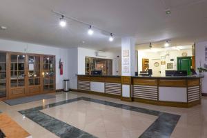 a restaurant with a counter in the middle of a room at Ona Las Brisas in Playa Blanca +12 photos