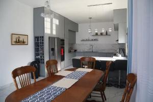 a kitchen with a wooden table and chairs and a dining room at Located in a quiet area ! in Durrës