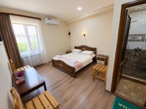a bedroom with a bed and a table and a chair at NUR TOON in Areni