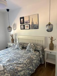 a bedroom with a bed and some pictures on the wall at La casa del papica in Níjar