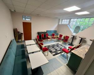 a waiting room with chairs and tables and a couch at DOKK Agárd in Gárdony