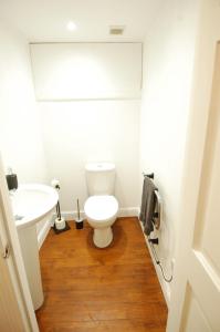 a bathroom with a toilet and a sink at Baker Street Retreat in Stirling