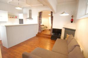 a living room with a couch and a fireplace at Baker Street Retreat in Stirling