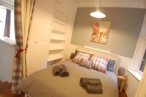 a bedroom with a bed with two bags on it at Baker Street Retreat in Stirling