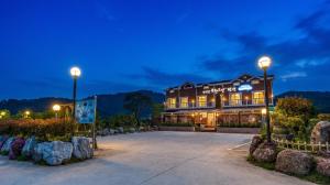 a building with two lights in front of it at Suncheonman Muhan Dojan Pension in Suncheon