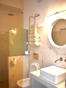 a bathroom with a sink and a mirror at Pension The Flower in Oia