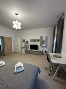 a bedroom with a bed and a table and a desk at Vera Residence - Free Private Parking & Self Check-In in Timişoara