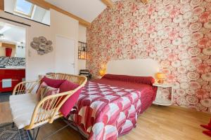 a bedroom with a bed and two chairs at Chambres D'hôtes Le Cocon in Saint-Paul-les-Fonts +35 photos