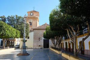 a building with a clock tower on top of it at La casa del papica in Níjar