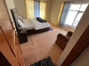a small room with a bed and a window at The Norbu Retreat Hull in Kaza +19 photos
