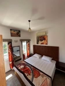 a bedroom with a large bed and a mirror at CİELO Otel in Bodrum City