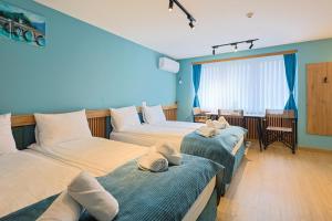 a room with two beds with hats on them at FourMountains-Bjelašnica in Sarajevo