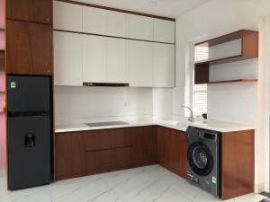 a kitchen with a washer and a dishwasher at Villa SeriGold - NovaWorld Phan Thiết in Tiến Thành