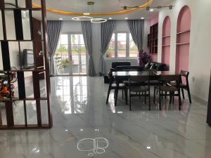 a dining room with a table and chairs at Villa SeriGold - NovaWorld Phan Thiết in Tiến Thành +9 photos