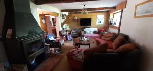 a living room with a couch and a table at chambre pour 2 à 4 personnes ,balcon in Mont-Saxonnex