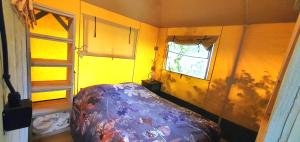 a small room with a bed and a window at Tent Ween at Glamping Verbaarum in Bedum +25 photos