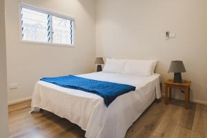 a white bed in a room with a window at Suva Point Ocean Front Nukulau Island Views in Suva