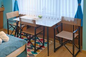 a dining table and chairs in a room at FourMountains-Bjelašnica in Sarajevo