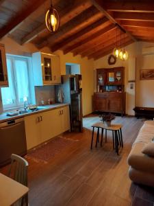 a kitchen and living room with a couch and a table at Lilly of Lemnos in Roussopoúlion