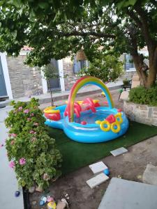 a small childs inflatable toy in a yard at Lilly of Lemnos in Roussopoúlion