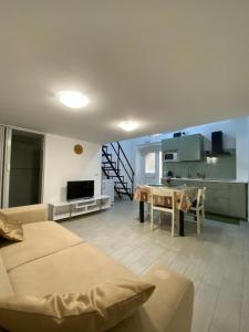 a living room with a couch and a table and a kitchen at MareLuna in Gaeta