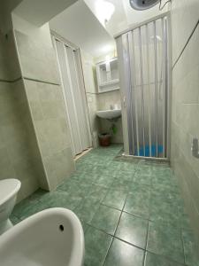 a bathroom with a shower and a toilet and a sink at MareLuna in Gaeta +5 photos