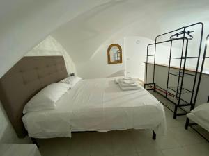 a bedroom with a white bed and a window at MareLuna in Gaeta