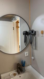 a bathroom with a mirror and a sink at ALAU villas in Saty +42 photos