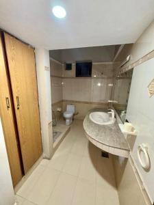a bathroom with a sink and a toilet at Karachi Family Guest House in Karachi