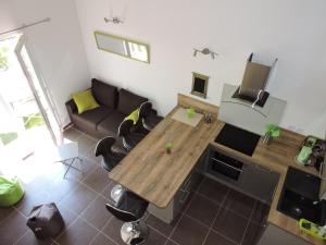 a living room with a wooden table and a couch at Les Provences Bleu et Verte in Solliès-Pont