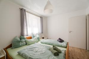 a bedroom with two beds and a window at Haus Redi in Sasbach in der Ortenau