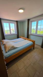 a bedroom with a bed in a room with two windows at New Big Butterfly Rooms - Free parking in Koper