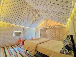 a bedroom with a bed in a room with polka dots at Big Brand Desert Camp in Jaisalmer +27 photos