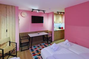 a room with two beds and a pink wall at FourMountains-Igman in Sarajevo