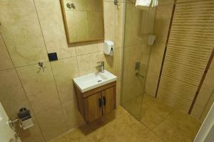 a bathroom with a sink and a shower at Doruk Pansiyon in Amasra +22 photos