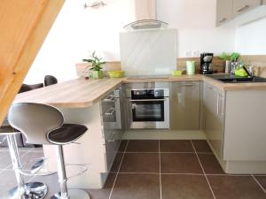 a kitchen with white cabinets and a counter top at Les Provences Bleu et Verte in Solliès-Pont
