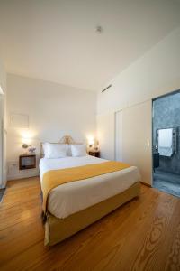 a bedroom with a large bed and a large window at Morgadio da Calcada Douro Wine&Tourism in Pinhão +76 photos