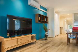 a living room with a large blue wall at Suva Point Ocean Front Nukulau Island Views in Suva